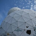 a white dome with a blue sky